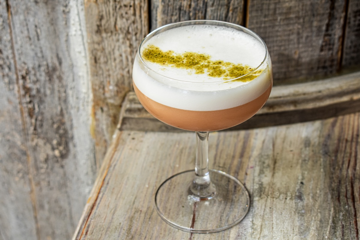 Patriarch Sour with rye whiskey, pomegranate molasses, calamansi and angostura,