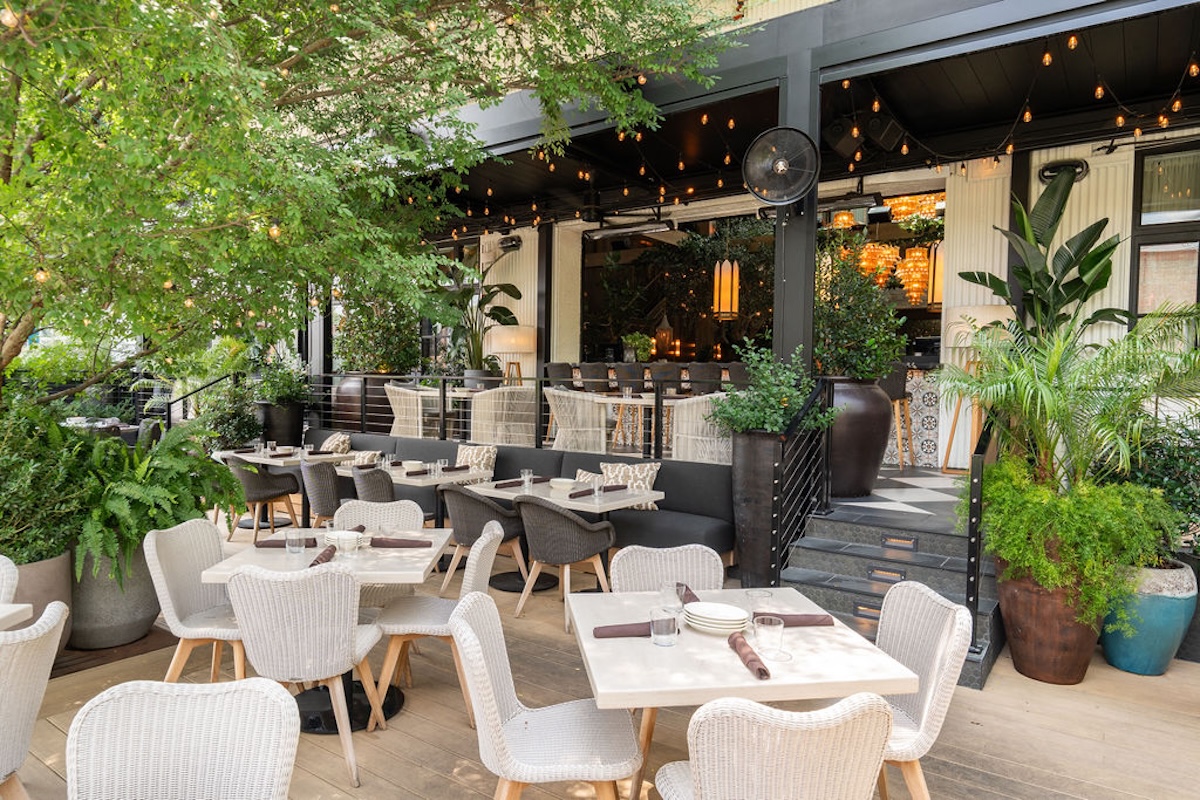 patio in nashville with tables and greenery and lights