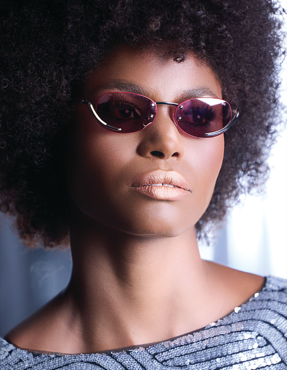 Portrait of Eliza in pink glasses with metal frames