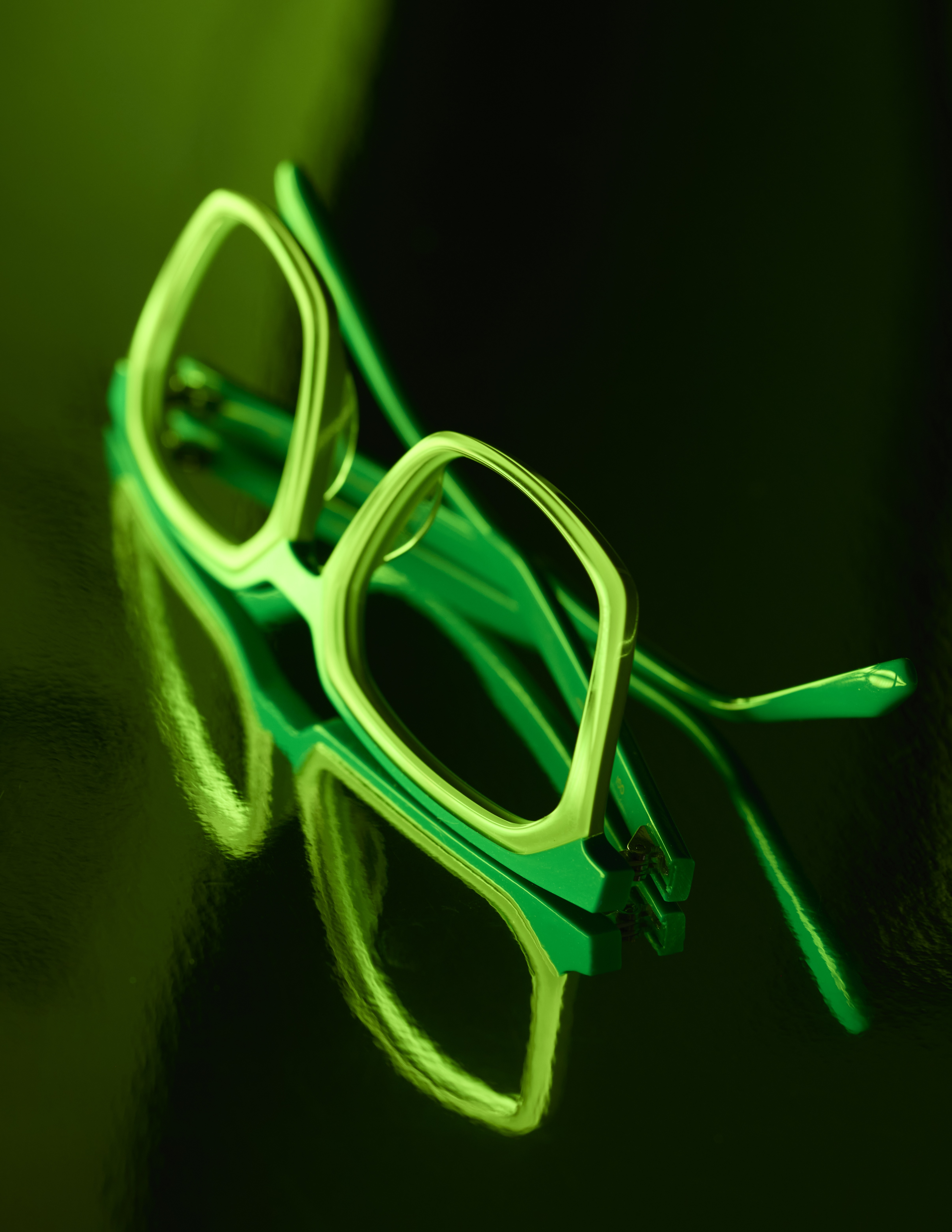 OGI eyewear photographed in dramatic green lighting