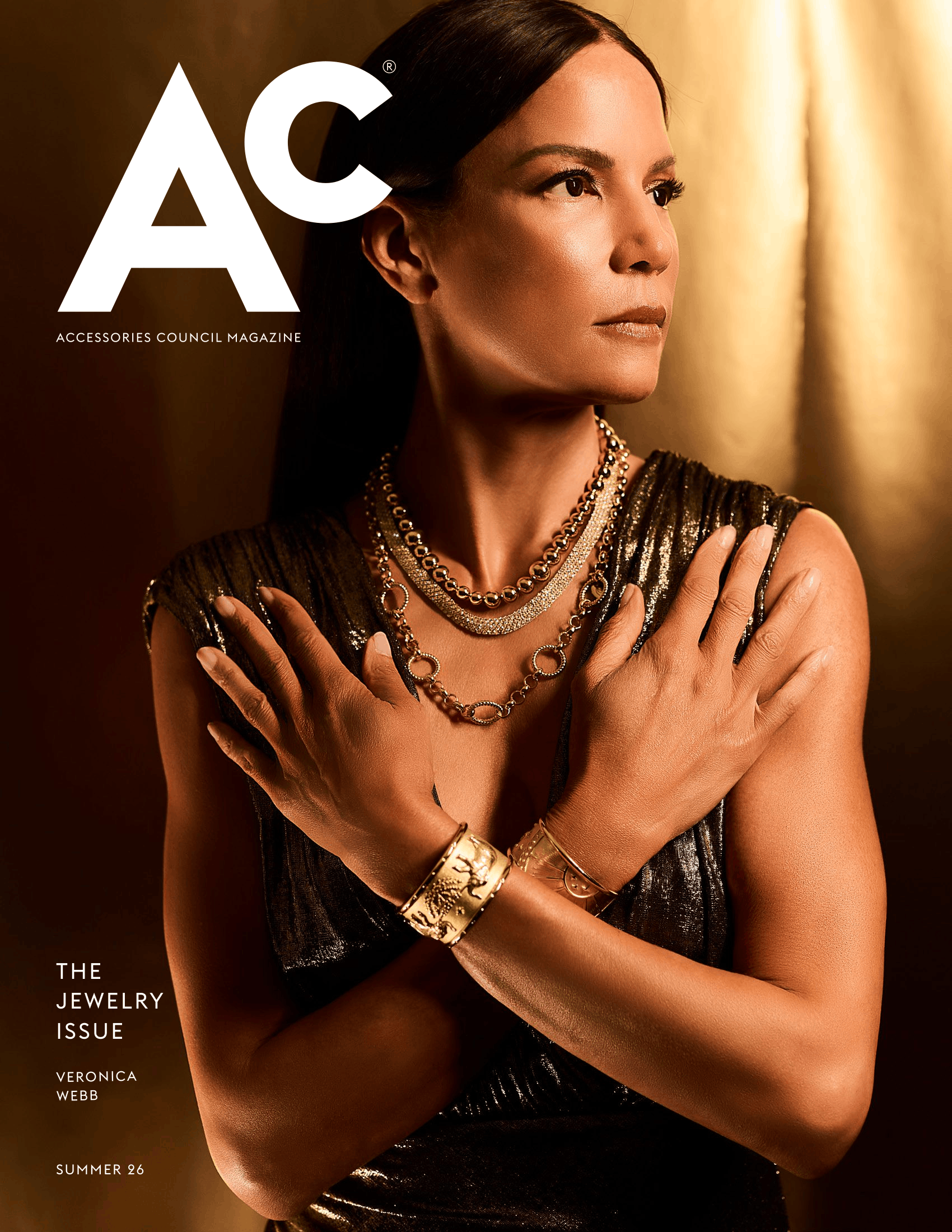 Cover of Ac Magazine’s Summer 2026 Jewelry Issue featuring Veronica Webb in a dramatic gold-toned portrait. Webb wears layered gold necklaces and wide cuff bracelets with a metallic black sleeveless dress, posing with her arms crossed against a warm bronze background.