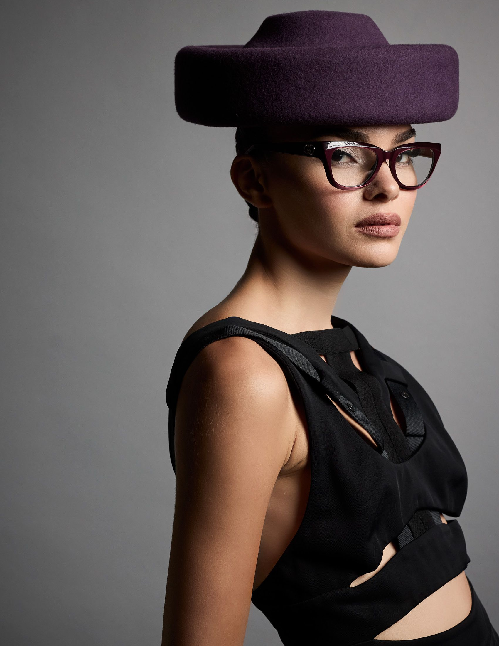 Model Brianna Ciarea Cirillo wearing Gucci sunglasses and dress, with a purple hat by ESENSHEL.