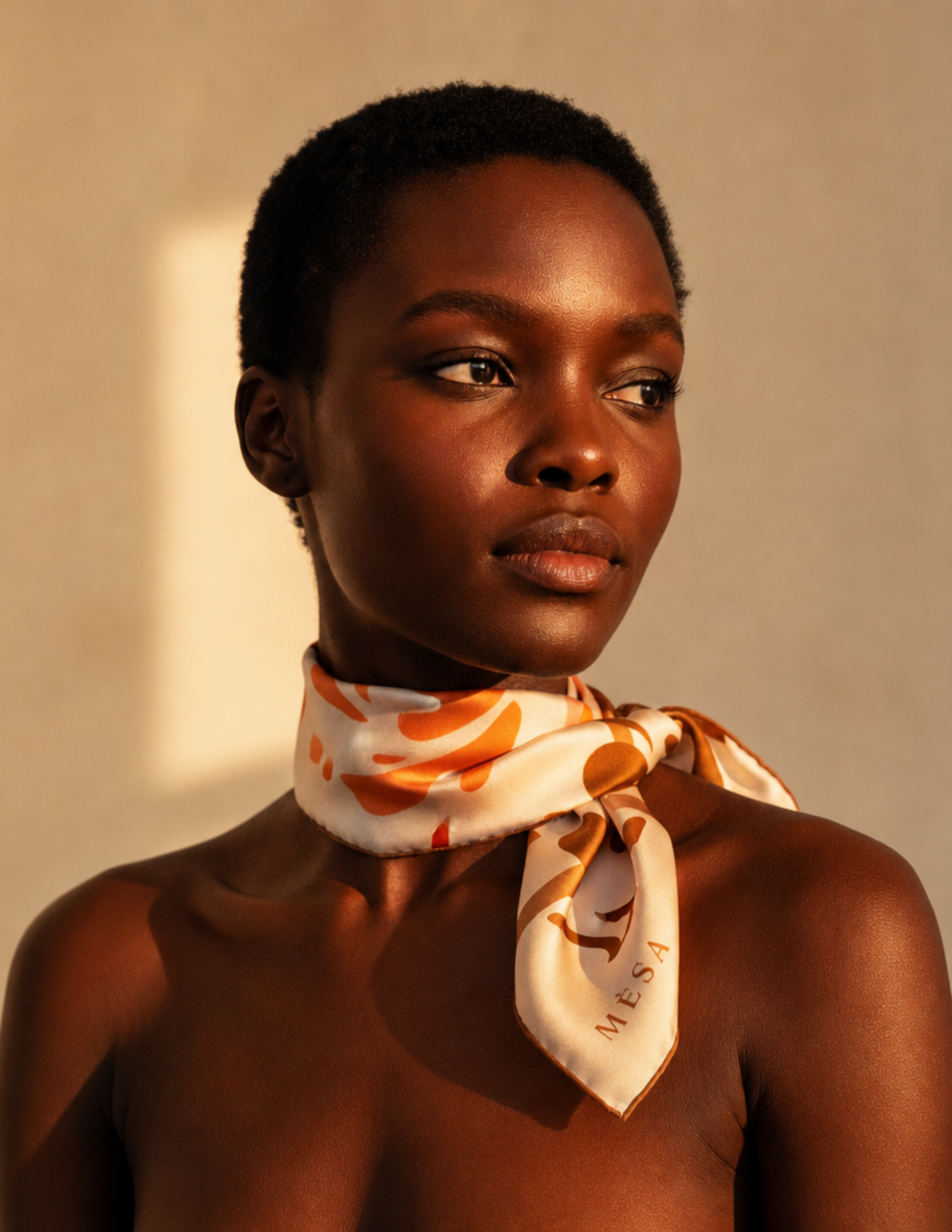 Model wearing a Mésan silk patterned neck scarf styled around the neck