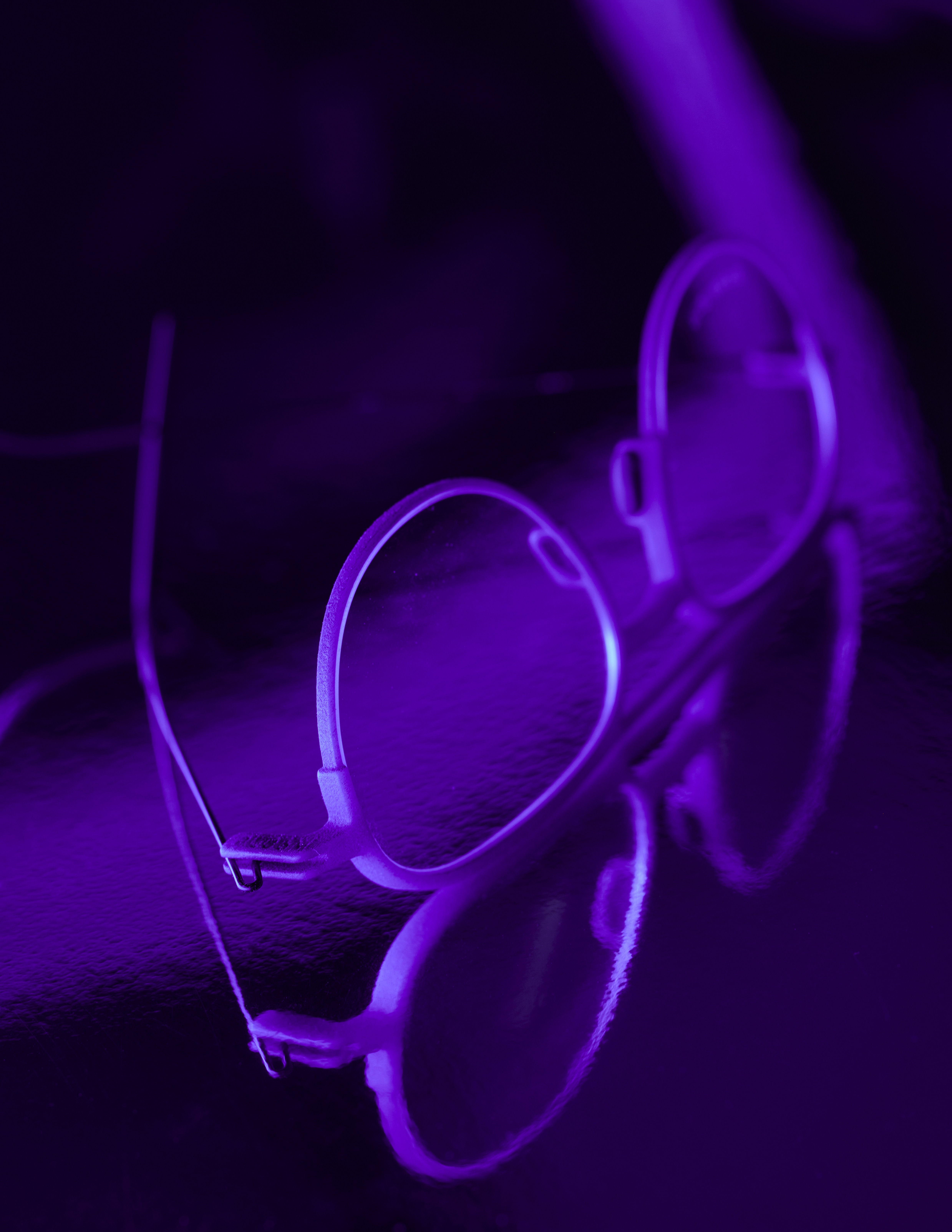 Annu eyewear photographed in dramatic purple lighting