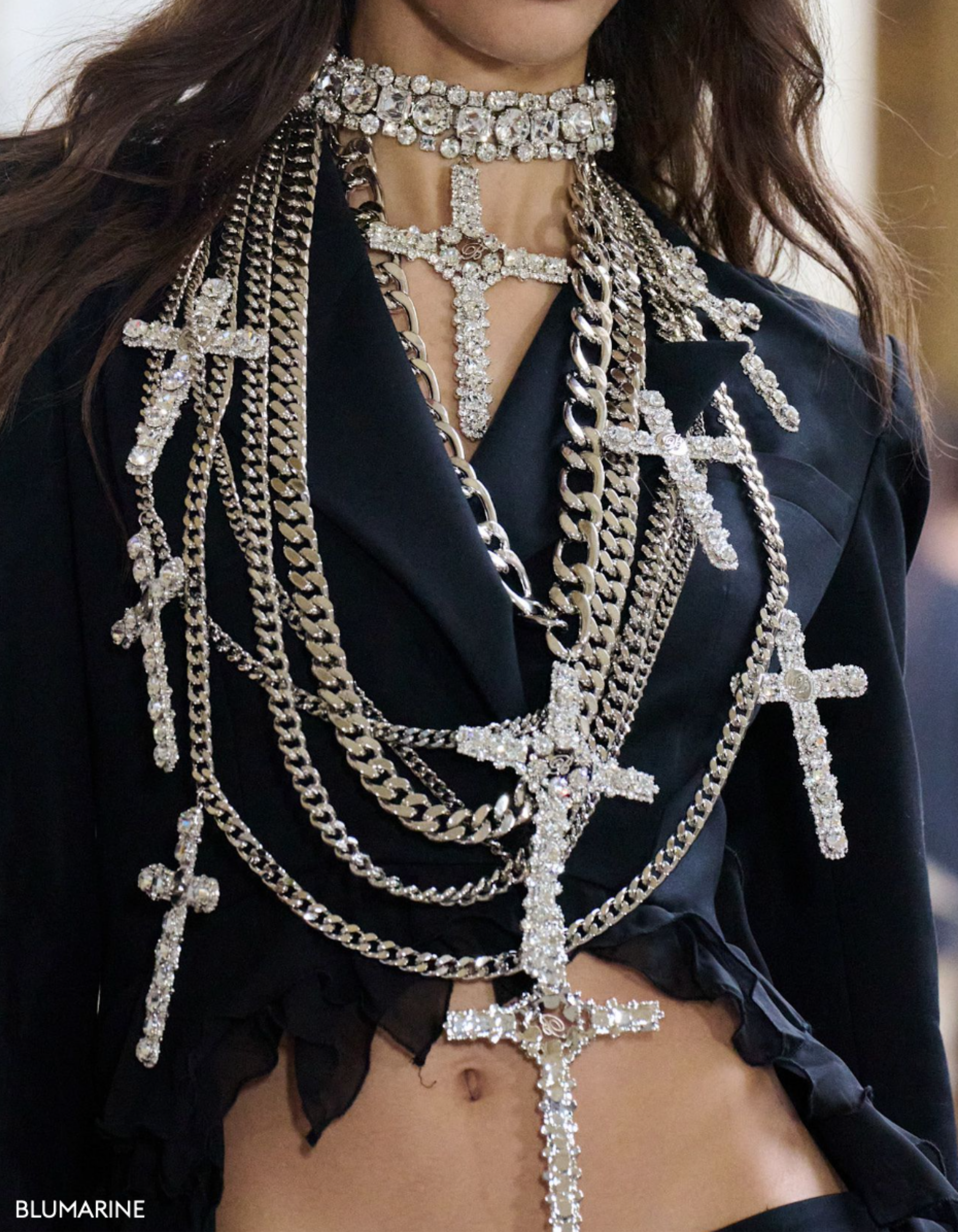 Runway image for Blumarine of a model wearing several diamond layered crosses