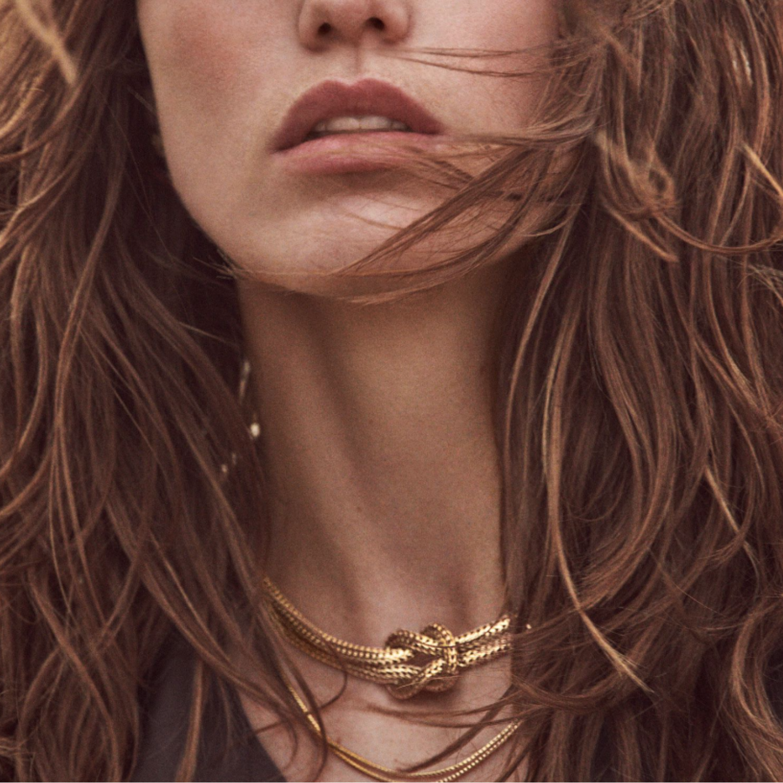 Close up of a model's neck wearing a John Hardy necklace