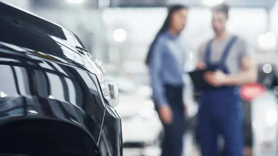 Why Service Here Man and Woman in car repair shop