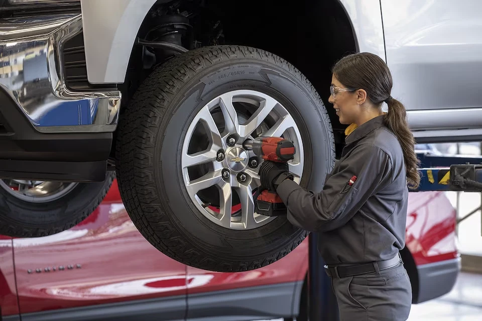 Chevy Technician working on a Chevy tire on the lift