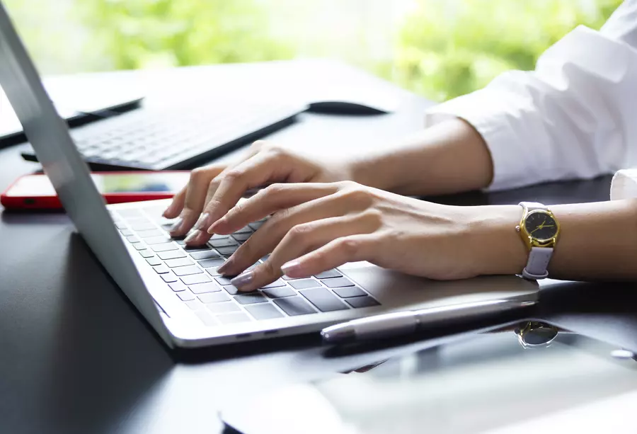 Closeup of womans hands working on a computer