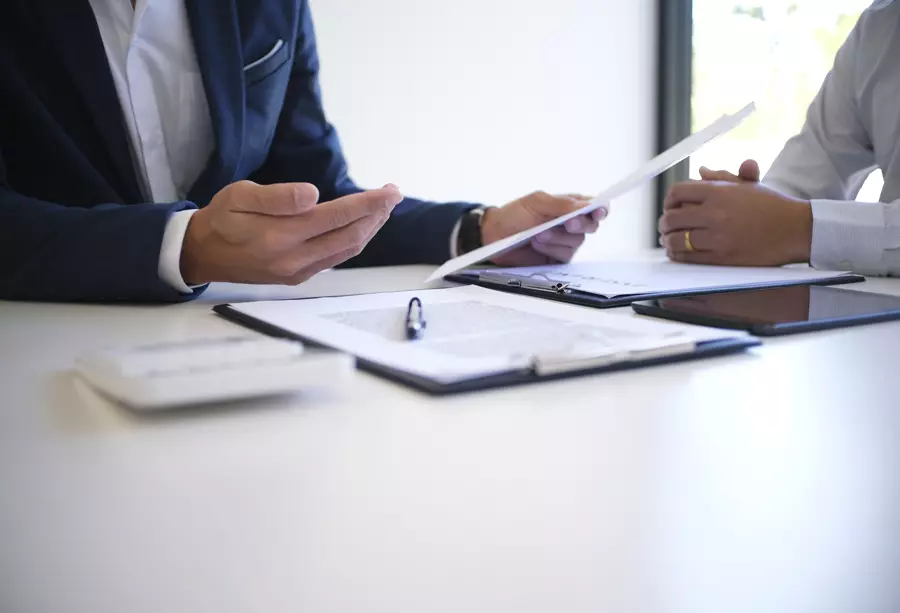 Closeup of men doing paperwork