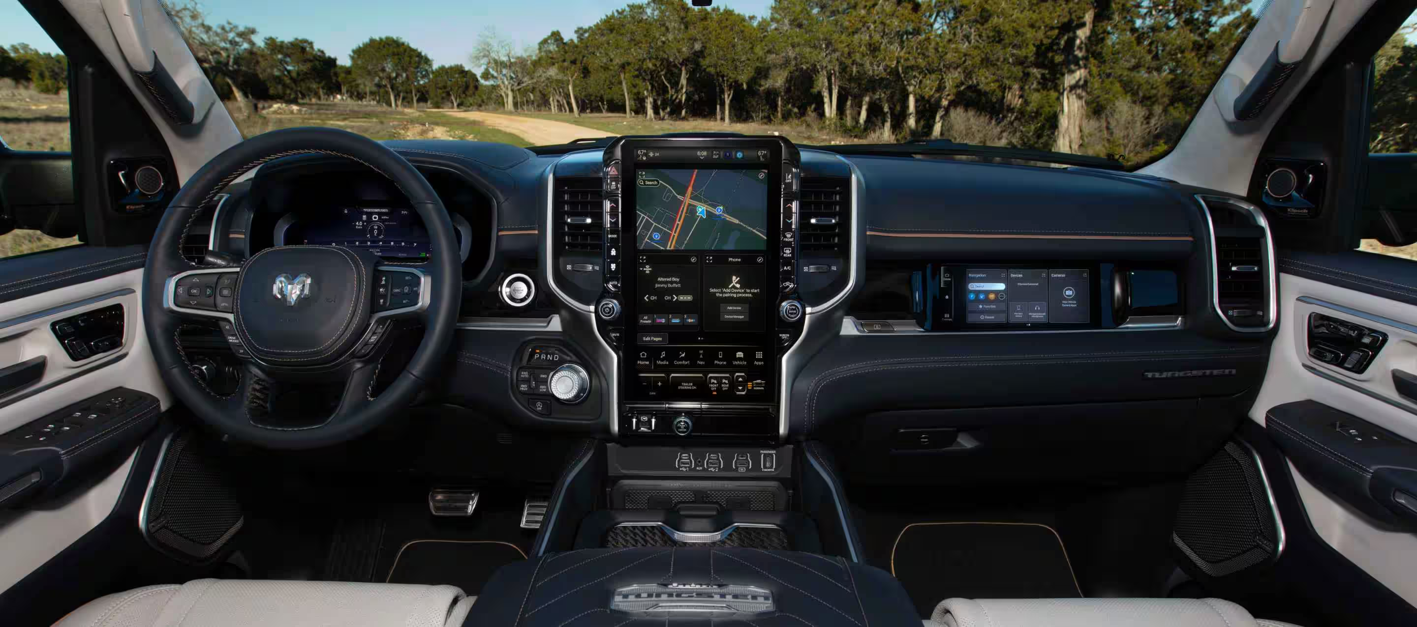 The steering wheel, Driver Information Digital Cluster, Uconnect touchscreen and front Passenger Interactive Display in a 2025 Ram 1500 Rebel.