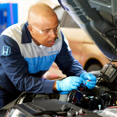 Service technician working under the hood