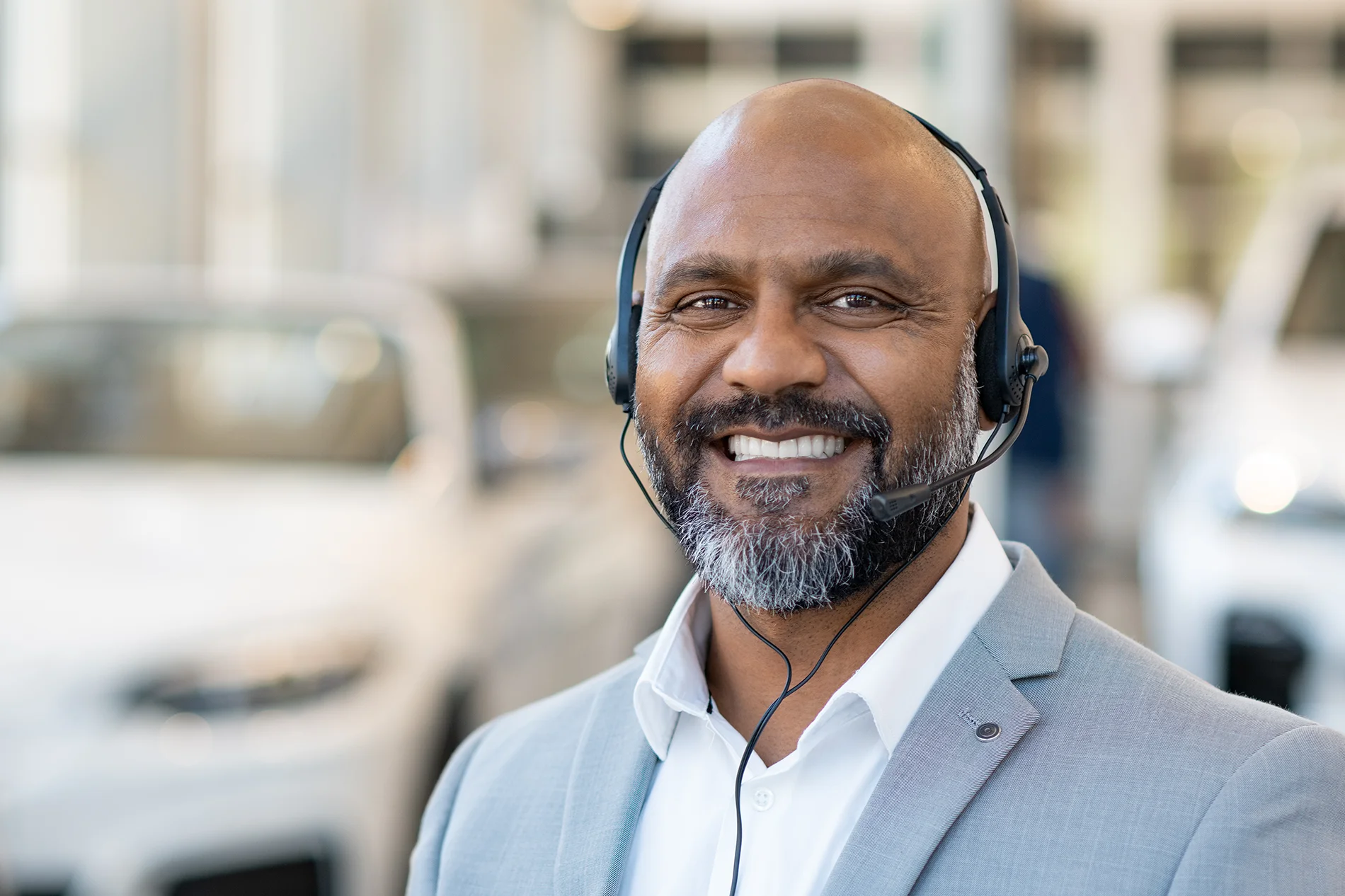 A man smiling with a headset on