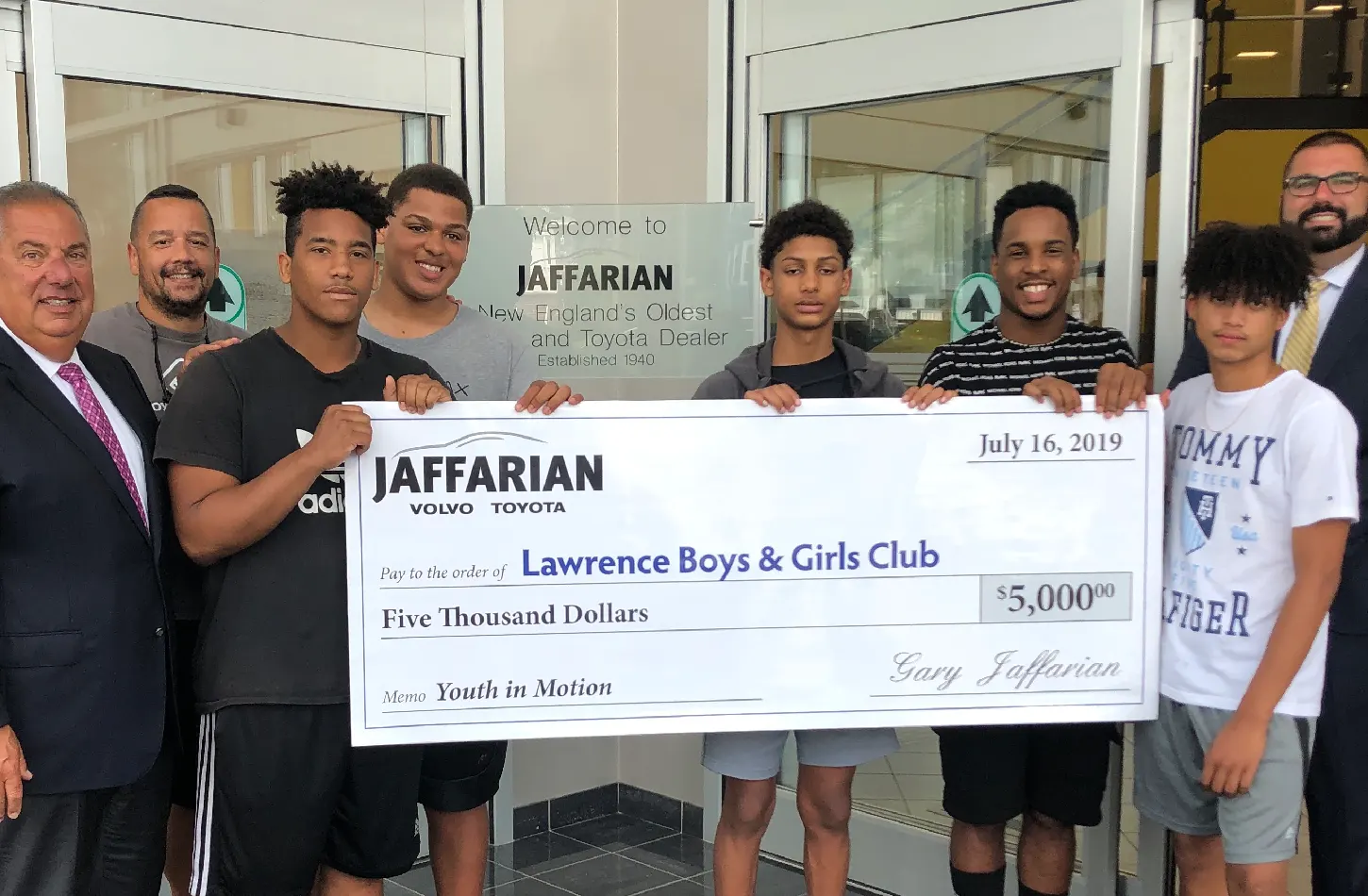 Gary Jaffarian with members of the Lawrence Boys and Girls Club holding a big check