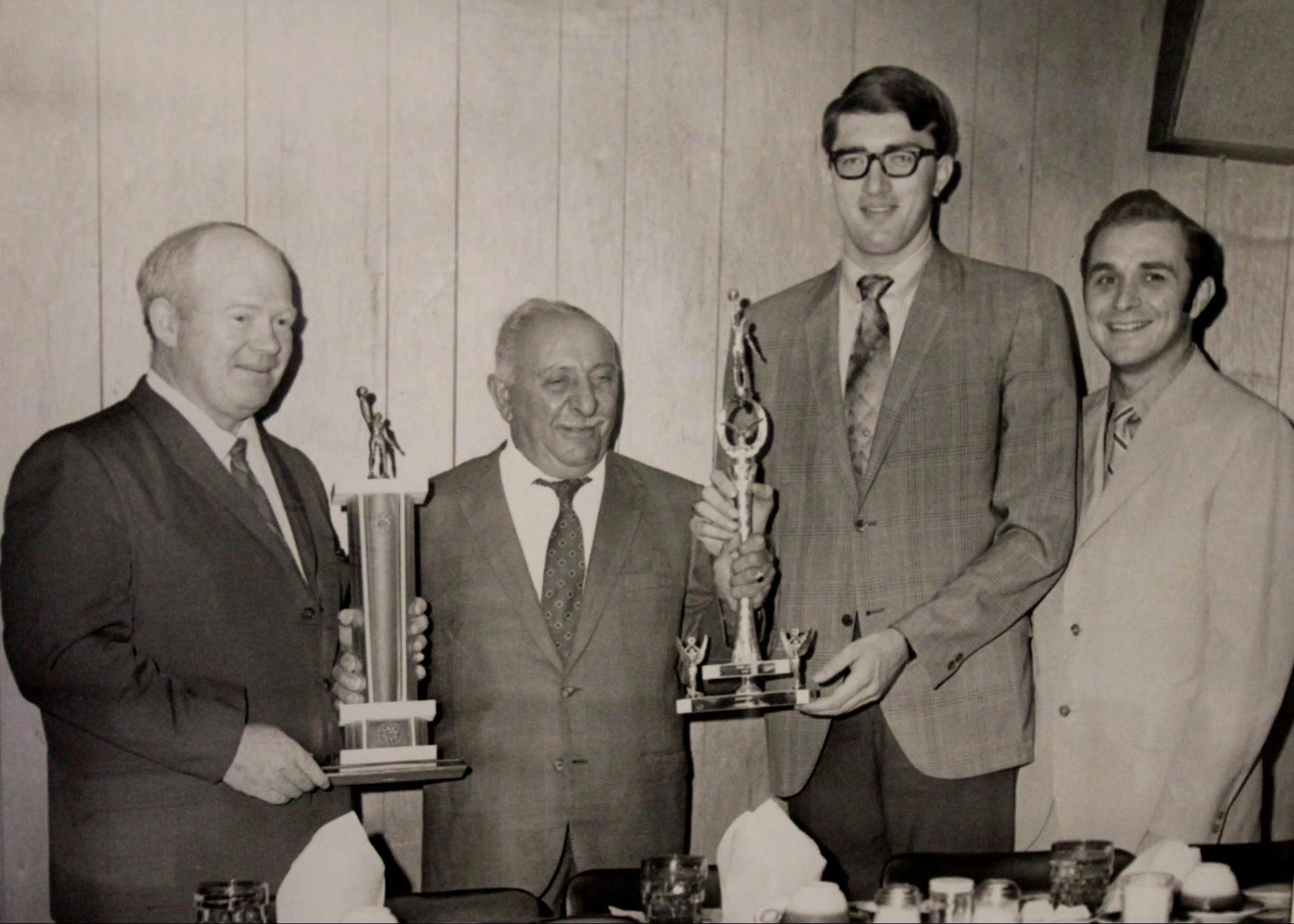 Group being presented with trophies