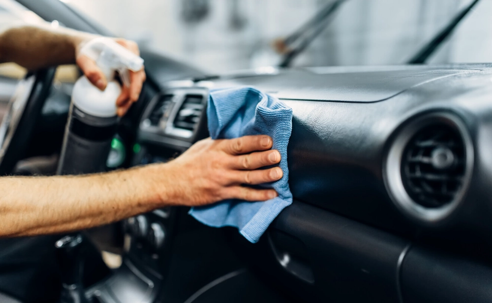 A Lexus technician detailing a vehicle