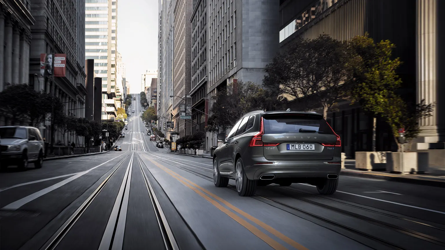Volvo driving down a city street