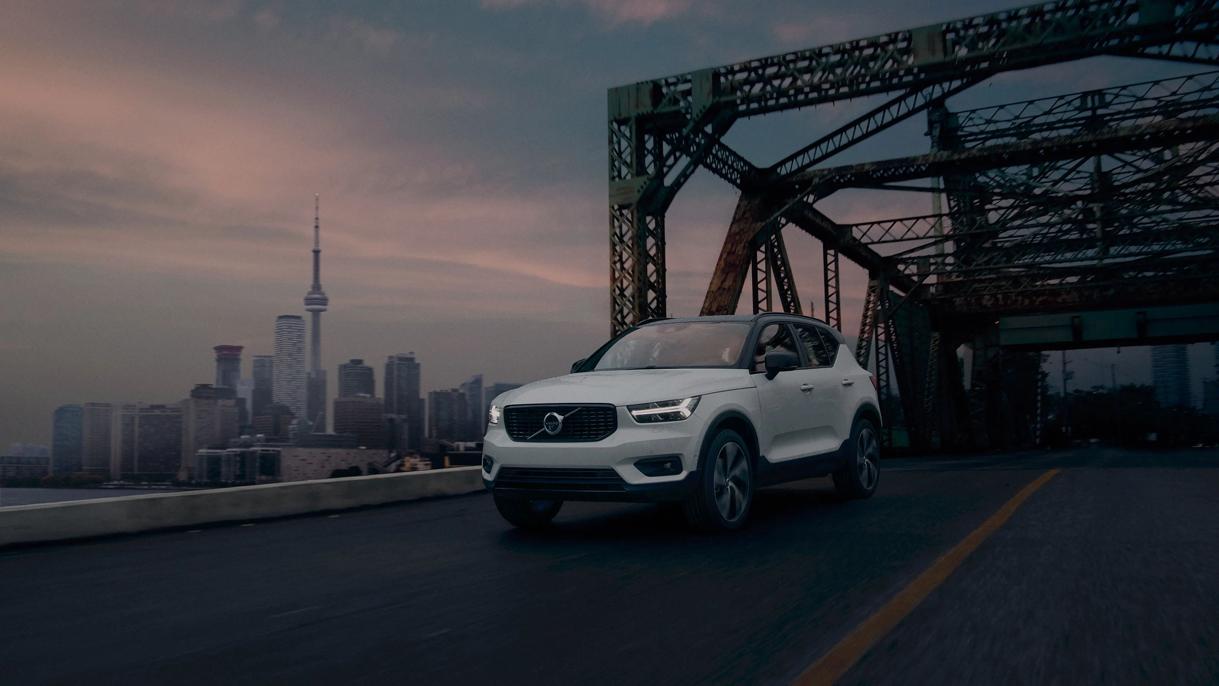 Volvo driving away from the city of a bridge