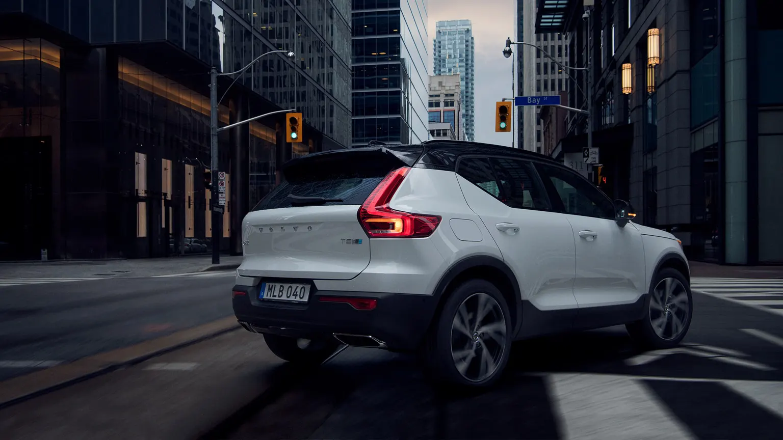 White Volvo drigin through the city
