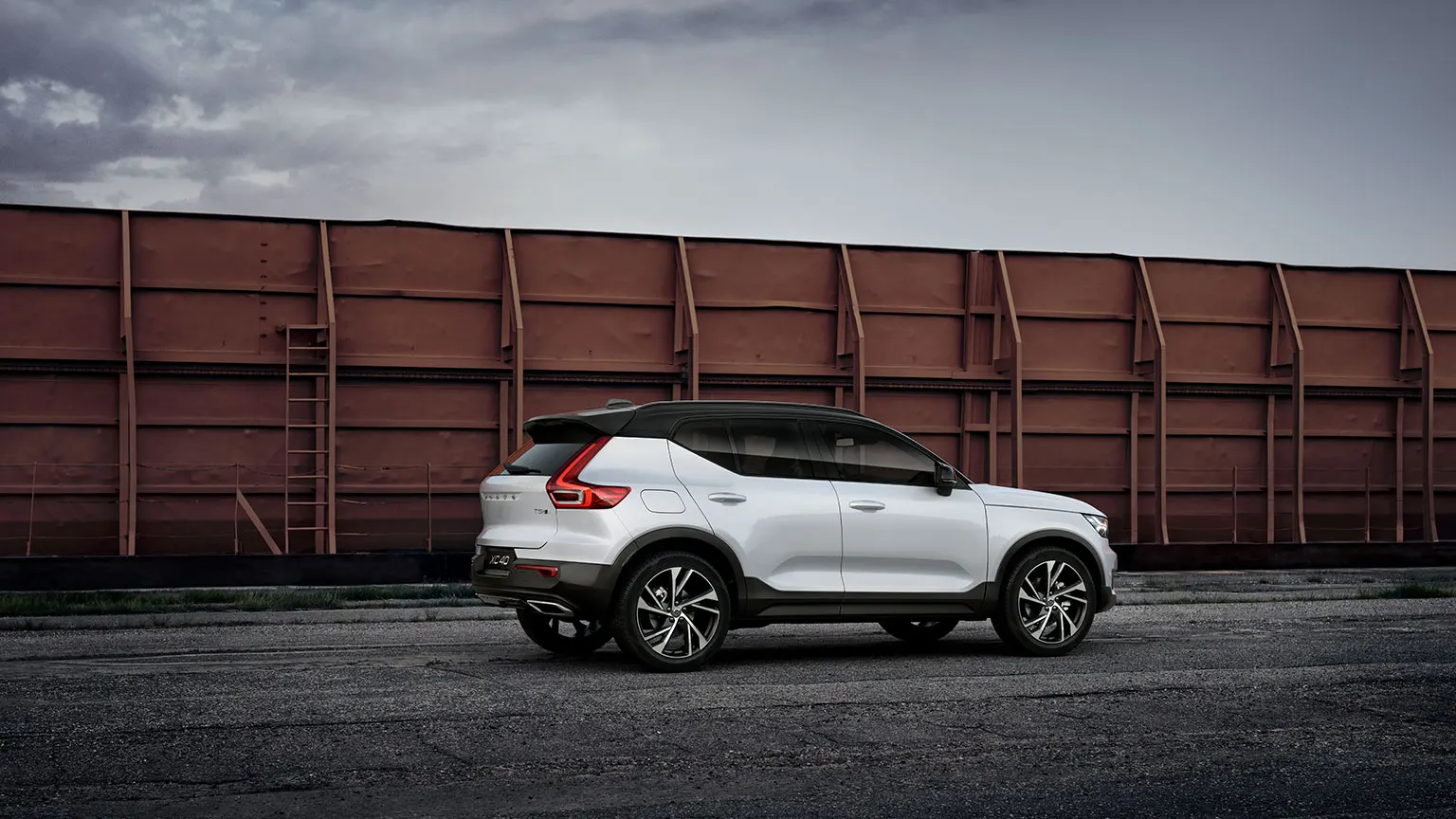 White Volvo parked in front of a wall