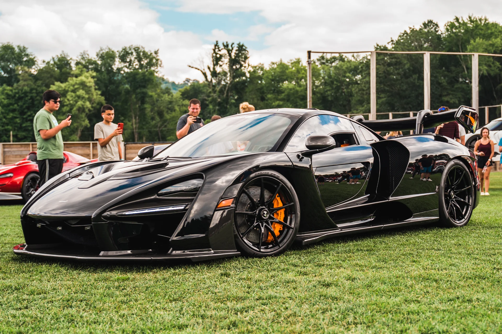 Black McLaren parked in a field