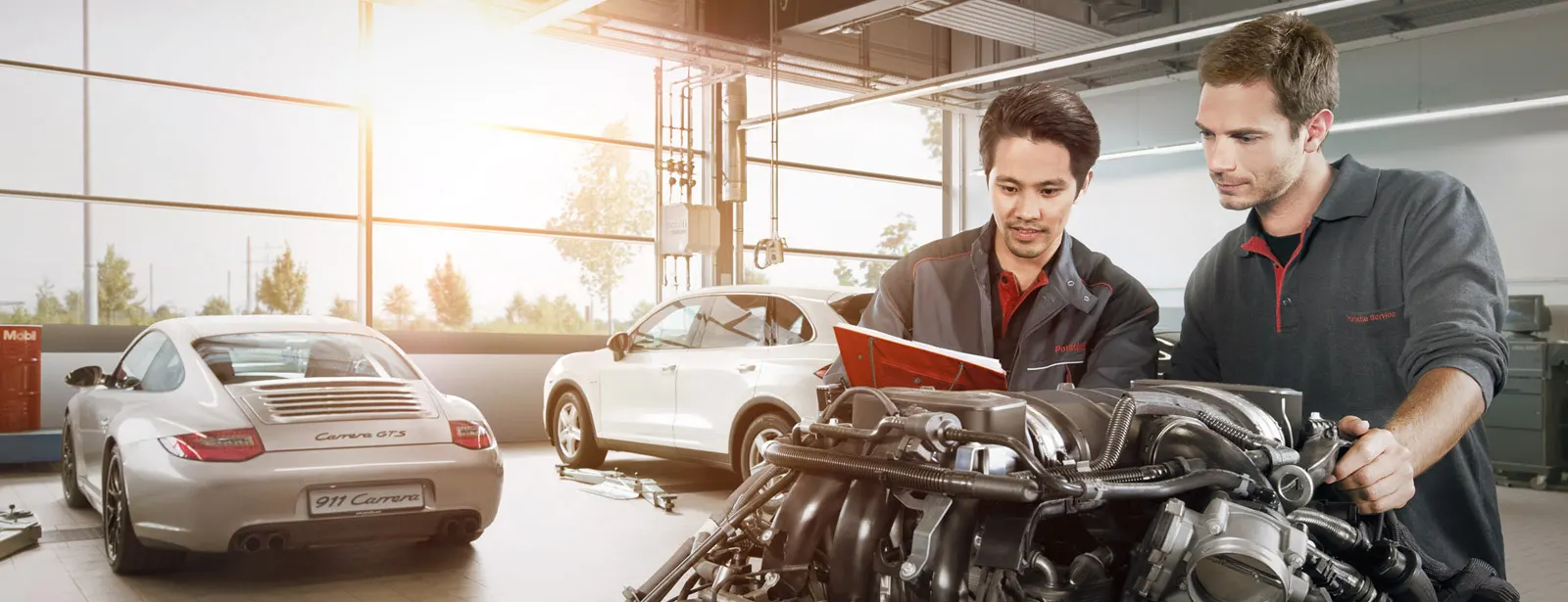 Porsche Technicians Working on Engine