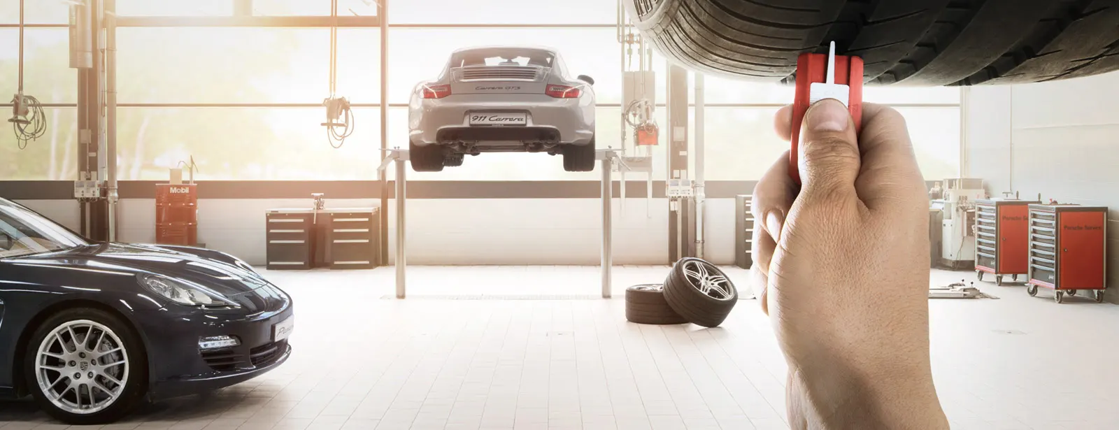 Porsche Technician checking tire