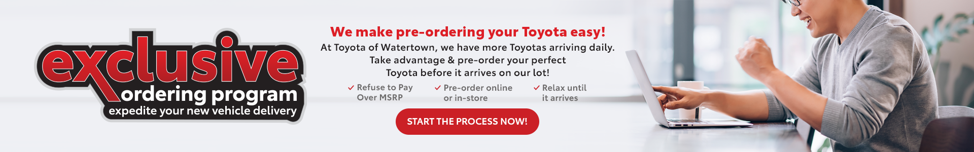 An Asian man sitting at his computer excited about ordering his new car at Toyota of Watertown