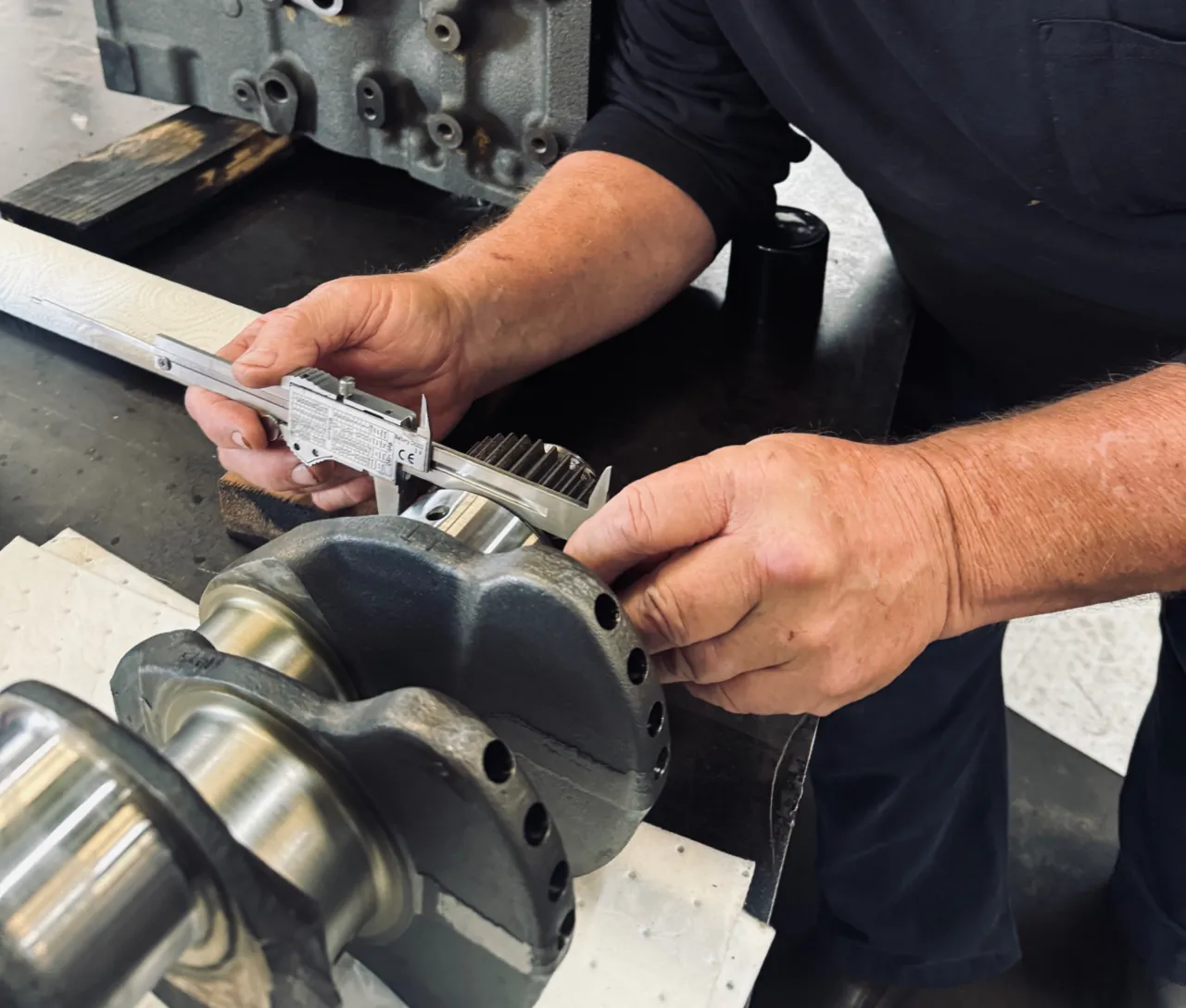 ADR technician performing precision measurements on marine engine components