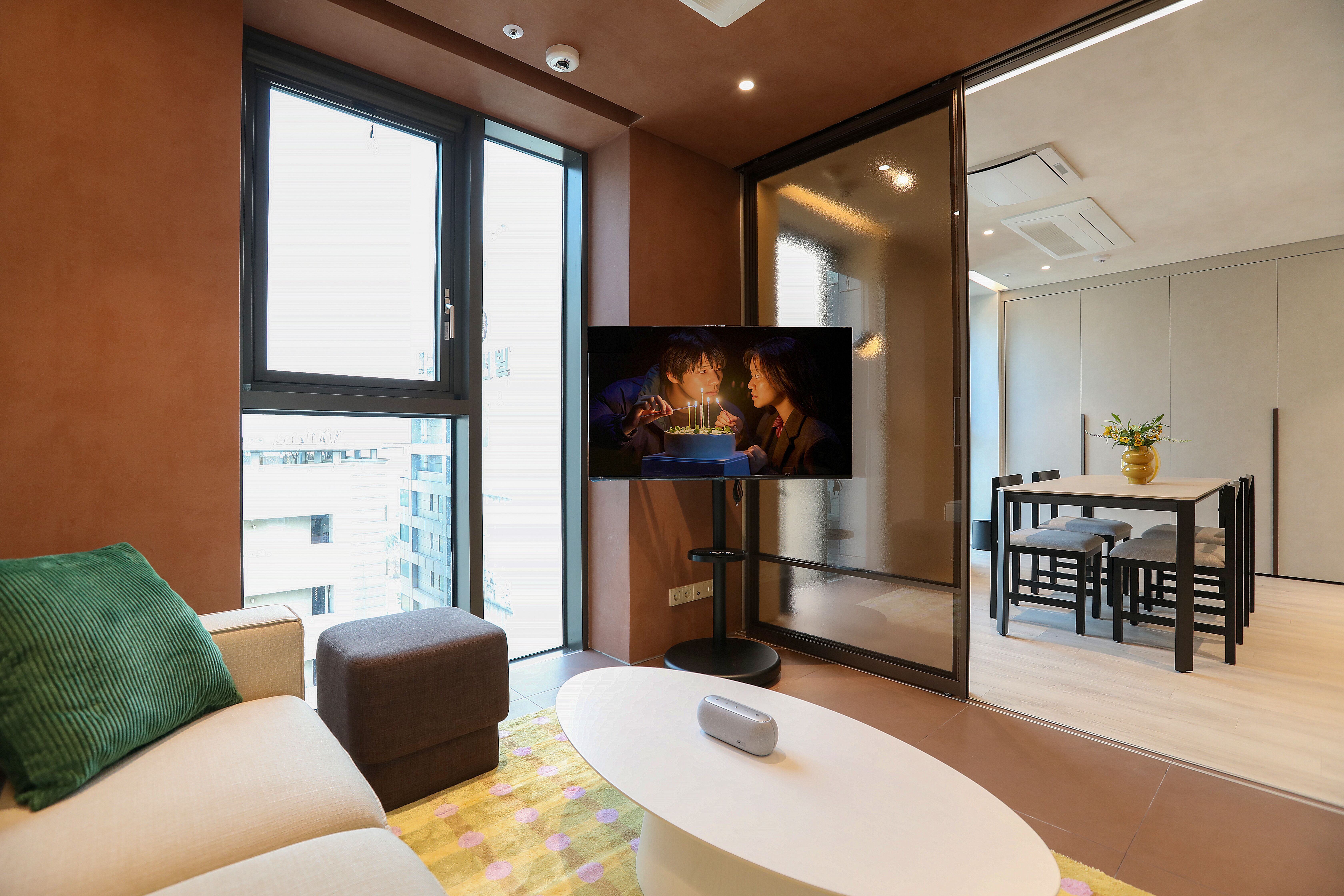 A modern luxury residence interior featuring a fully equipped kitchen and living space, offering a practical alternative to standard hotel rooms for extended medical stays.