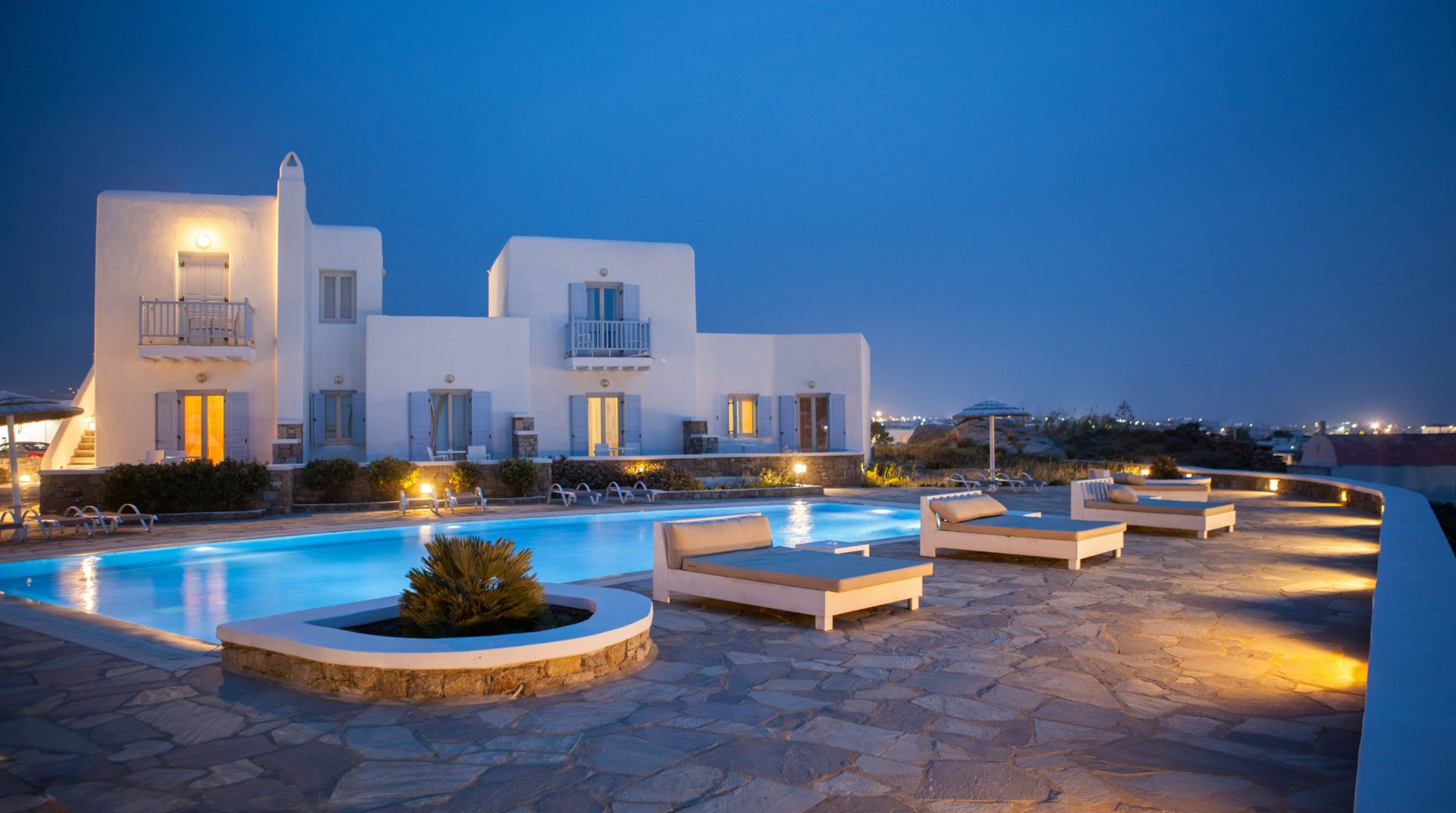 The Sunset Wing with the sunbeds, the pool and the hotel in the background