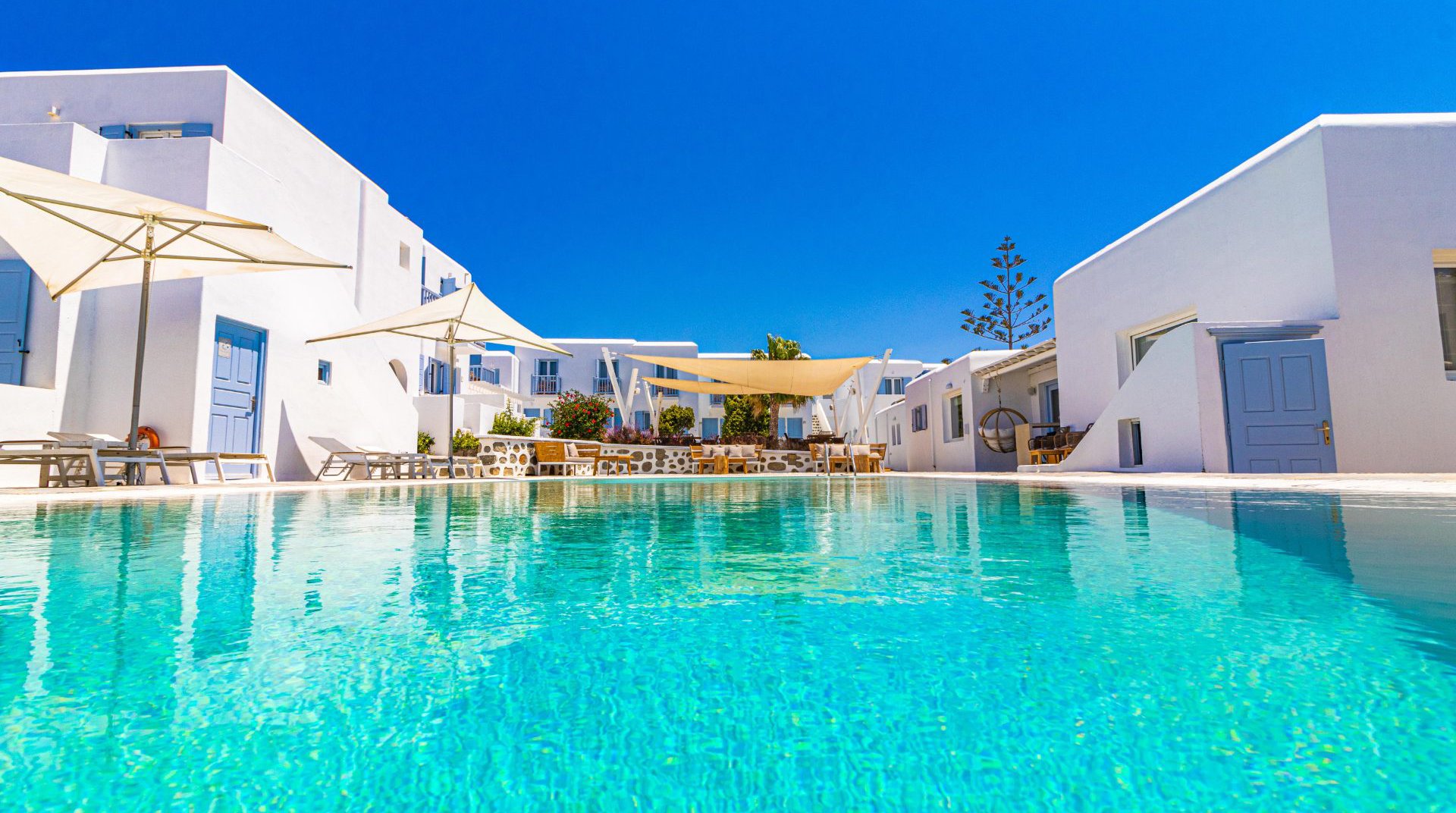 The pool of the Main Section with the sunbeds and the restaurant