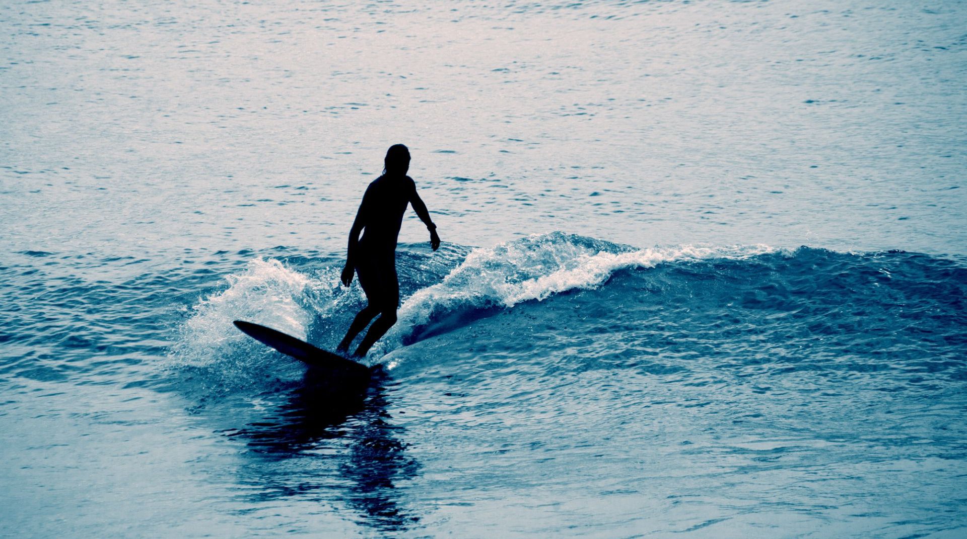 A person surfing on the seas of Mykonos