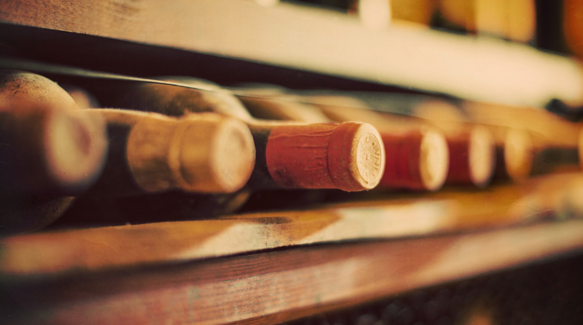 Bottles of wine on a wooden shelf