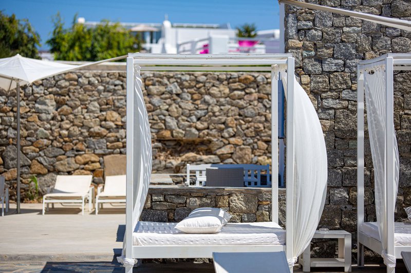 The outdoors beds and sunbeds by the pool