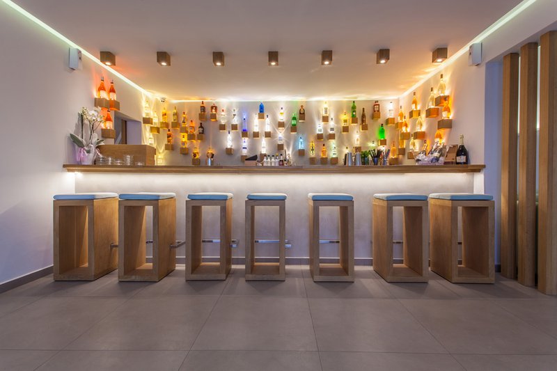 The bar of the resort, with the drinks and the chairs