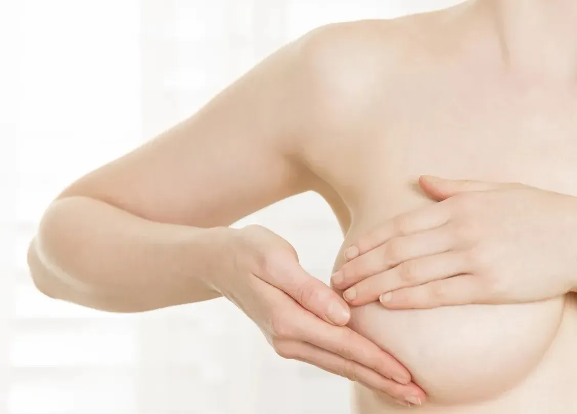 Woman with her hand in front of her chest