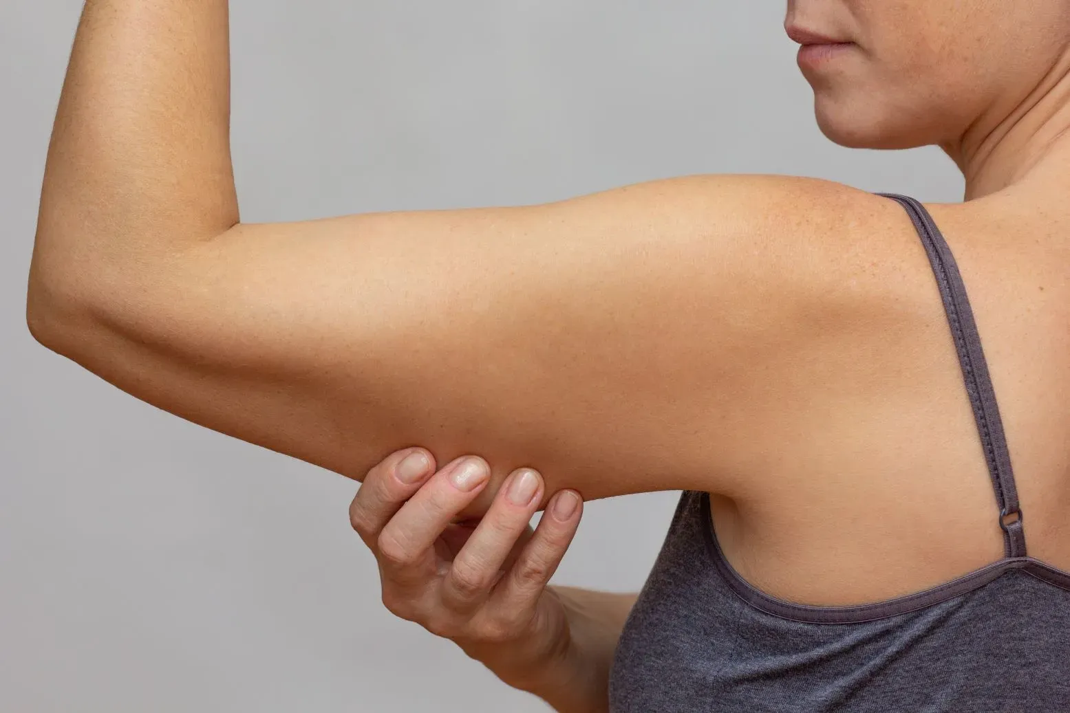 Woman is holding her triceps