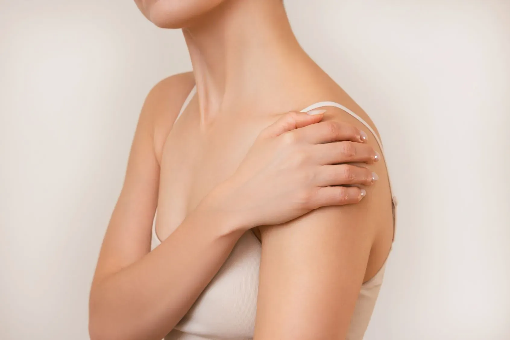 Woman holding her shoulder