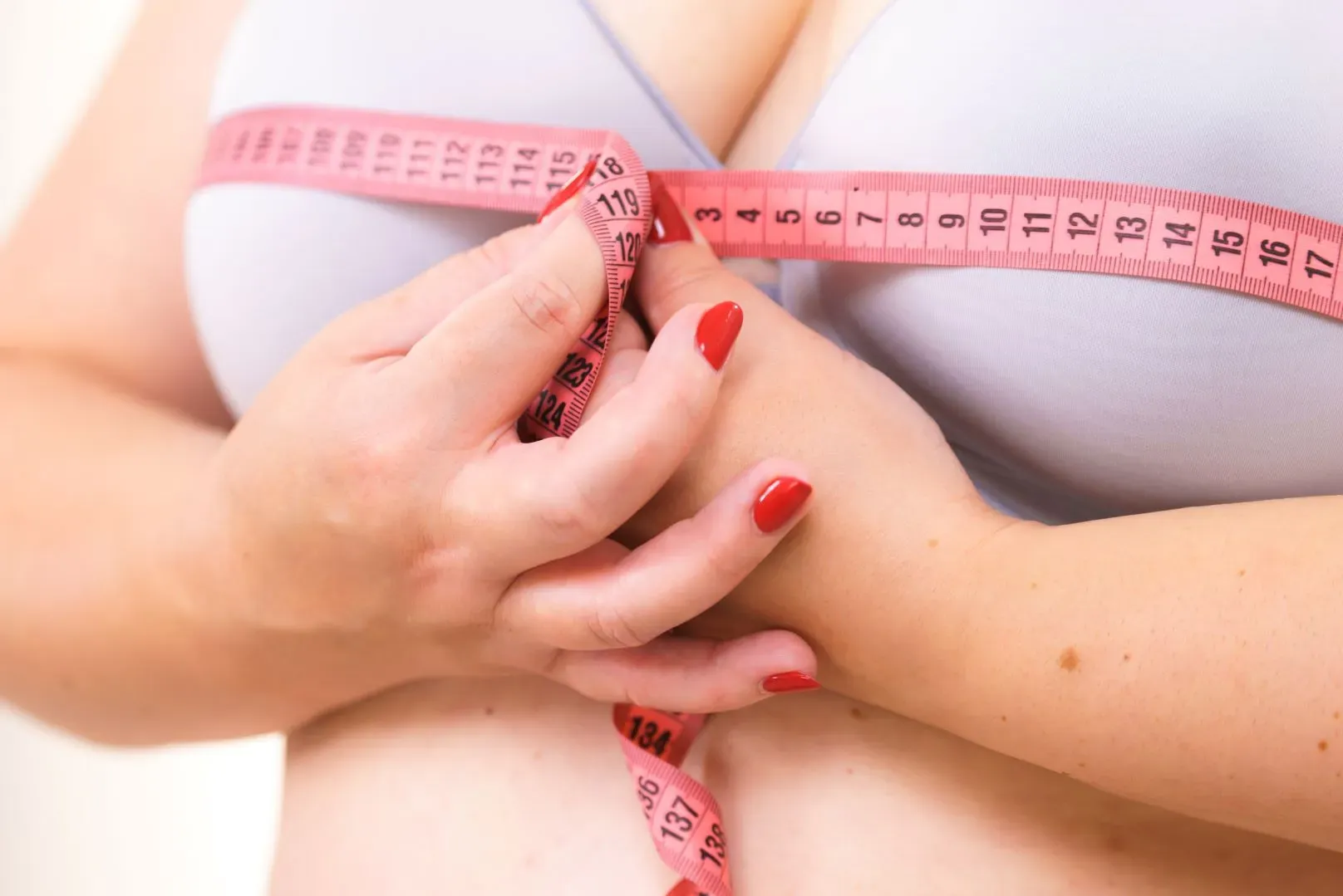 Woman measuring her bust circumference