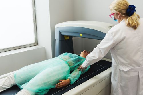 Medical professional assisting a patient undergoing a DEXA scan