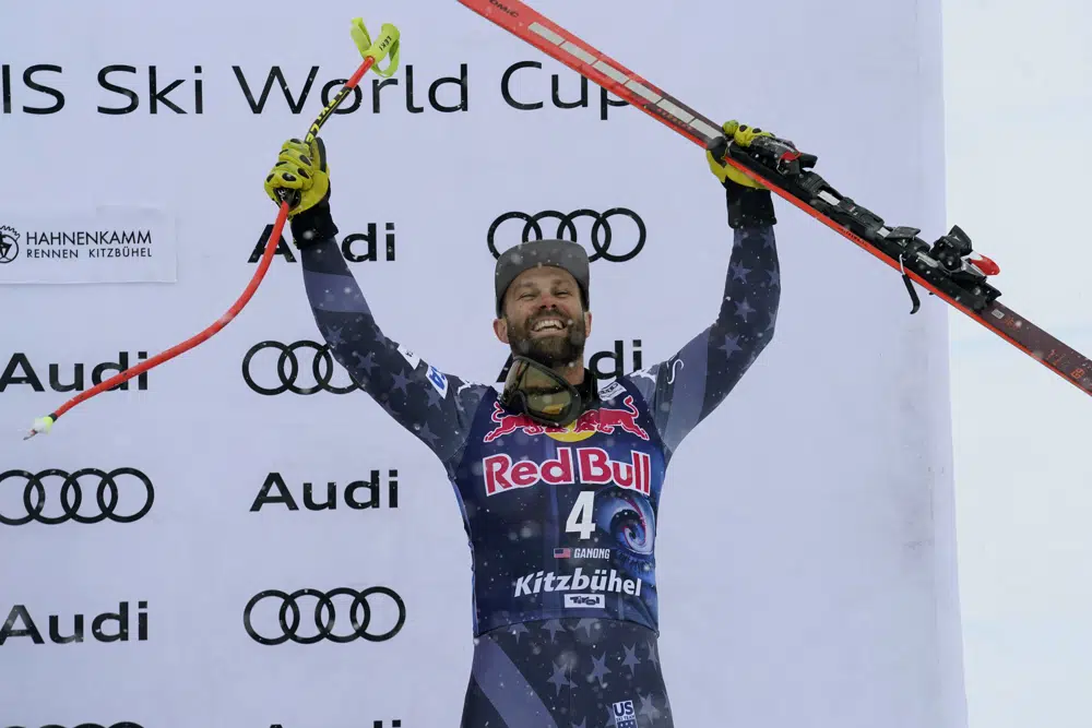 Third place United States' Travis Ganong celebrates on the podium after an alpine ski, men's World Cup downhill race in Kitzbuehel, Austria, Saturday, Jan. 21, 2023. (AP Photo/Giovanni Auletta)