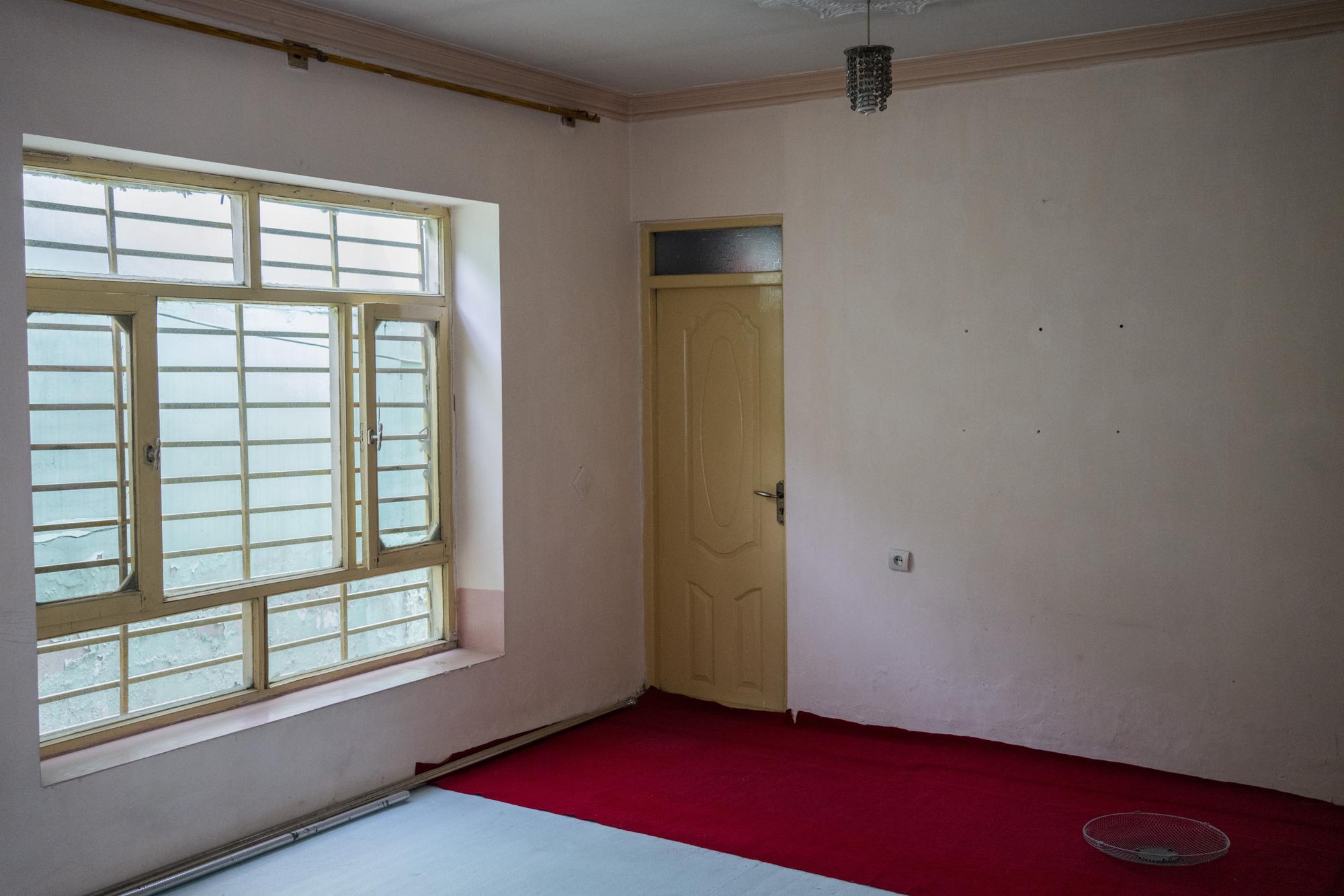 Light shines through an empty empty room of Ahmadullah's family house in Kabul, Afghanistan, Tuesday, Sept. 28, 2021. The family of seven sold their households as they are attempting to leave the country. (AP Photo/Bernat Armangue)