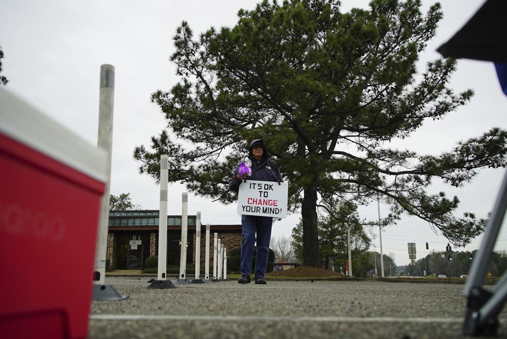 A protester paces the parking lot of the West Alabama Women's Center in Tuscaloosa, Ala., on Tuesday, March 15, 2022. The man belongs to a North Carolina-based Christian group called Love Life, which tries to convince people not to have an abortion. (AP Photo/Allen G. Breed)
