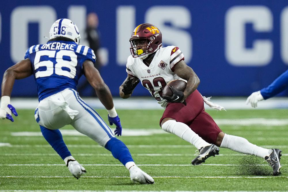 Washington Commanders running back J.D. McKissic (23) tries to get past Indianapolis Colts linebacker Bobby Okereke (58) in the first half of an NFL football game in Indianapolis, Sunday, Oct. 30, 2022. (AP Photo/AJ Mast)