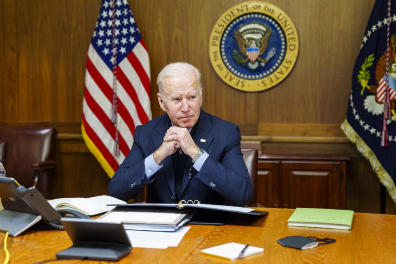 This image provided by The White House via Twitter shows President Joe Biden at Camp David, Md., Saturday, Feb. 12, 2022. Biden on Saturday again called on President Vladimir Putin to pull back more than 100,000 Russian troops massed near Ukraine’s borders and warned that the U.S. and its allies would “respond decisively and impose swift and severe costs” if Russia invades, according to the White House. (The White House via AP)