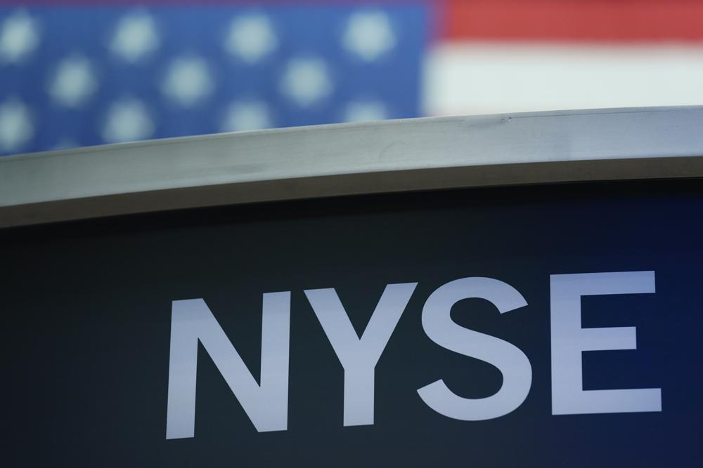 FILE- A sign for New York Stock Exchange is displayed on the floor at the NYSE in New York, July 27, 2022. Stocks are opening mostly higher on Wall Street ahead of a heavy week of earnings from big tech companies. Alphabet, Amazon, Apple and Facebook parent Meta are all reporting their latest quarterly results this week, as are Coca-Cola and General Motors. The S&P 500 rose 0.4% in the early going Monday, Oct. 24, 2022 and the Nasdaq slipped 0.4%. (AP Photo/Seth Wenig, File)