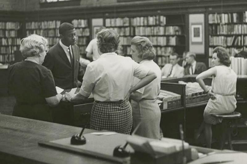 Miles College student Shelly Millender, standing in suit, is shown during an effort to desegregate the public library in Birmingham, Ala., on April 10, 1963. Millender, a Black Army veteran who helped peacefully desegregate an Alabama city's library with a sit-in protest in 1963, died on Saturday, July 17, 2021, according to the library and an obituary published by his family. He was 86.  (Birmingham News/Alabama Department of Archives and History via AP)