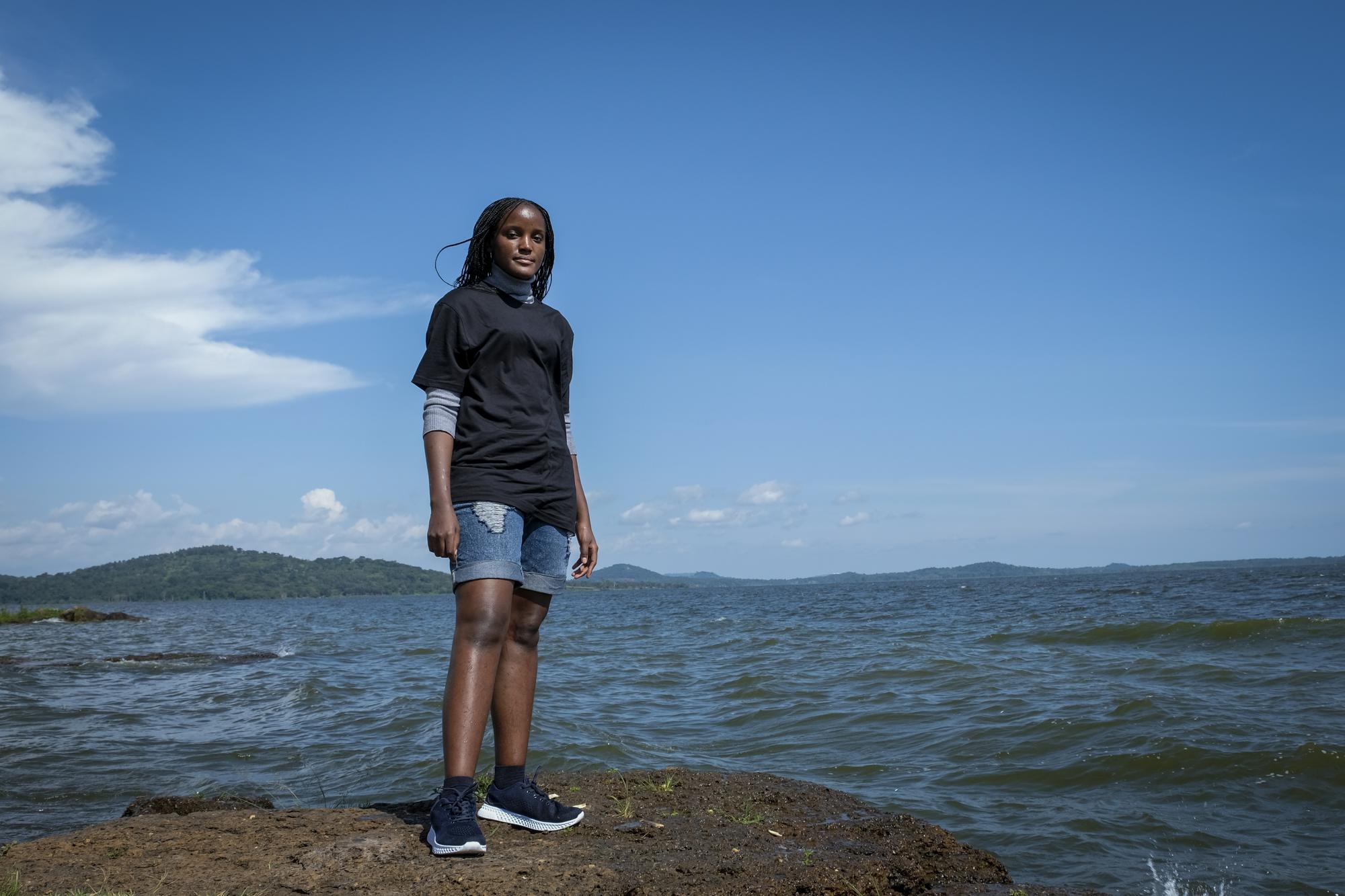 FILE - Ugandan climate activist Vanessa Nakate poses for a photograph on the shore of Lake Victoria on the outskirts of Kampala, Uganda, Dec. 6, 2021. At 26, Nakate of Uganda, is one of the older and better known of youth climate activists. She's spoken at international climate negotiations, written a book and won awards. (AP Photo/Hajarah Nalwadda, File)