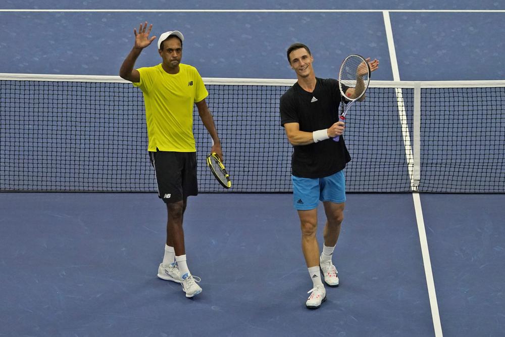 Rajeev Ram, left, of the United States, and Joe Salisbury, of Britain, celebrate after defeating Steve Johnson and Sam Querrey, both of the United States, in the men's doubles semifinals of the U.S. Open tennis tournament in New York, Thursday, Sept. 9, 2021. (AP Photo/Seth Wenig)